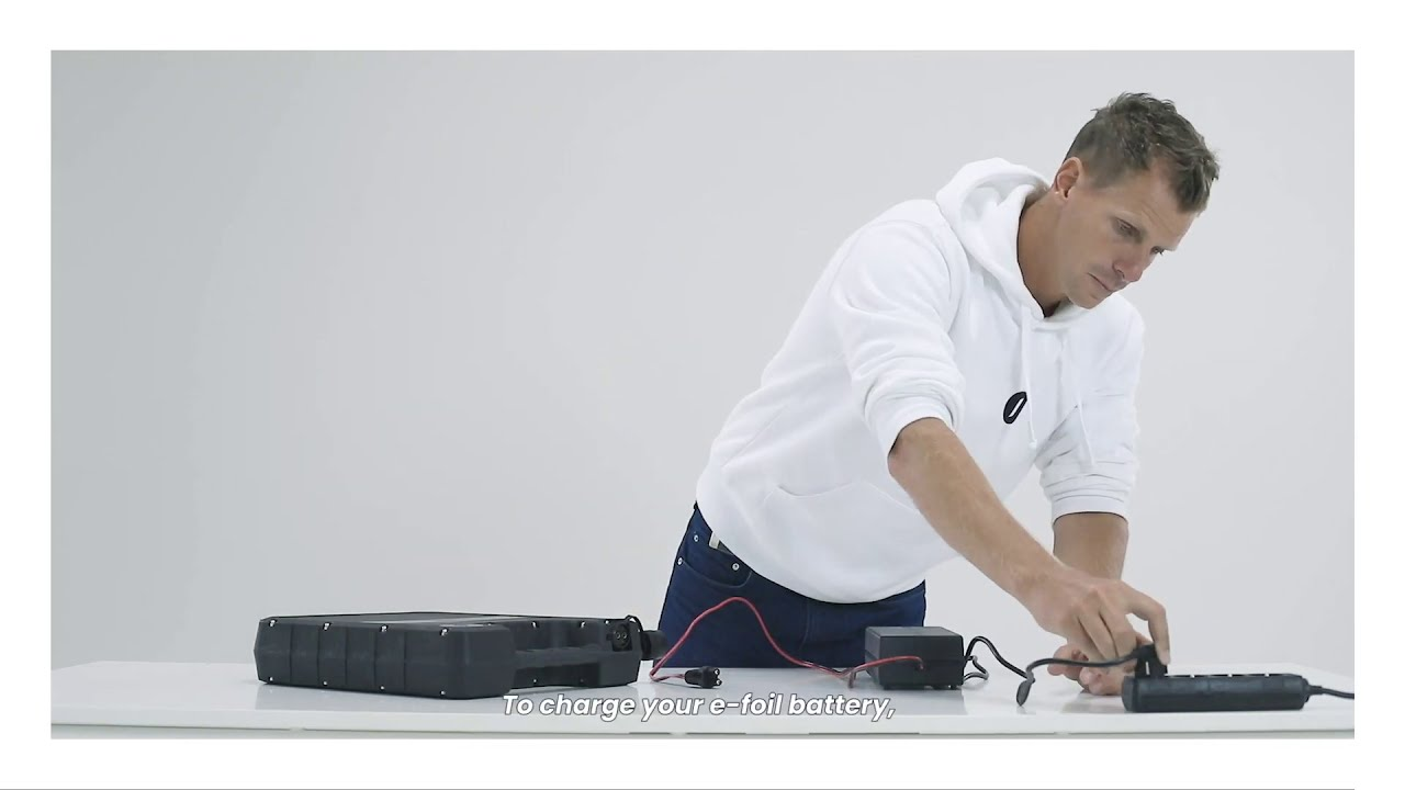 A person charging Lift3 4'9 Sport efoil battery