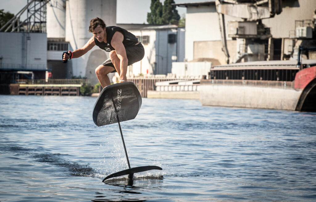 A person riding a board in calm and flat seas