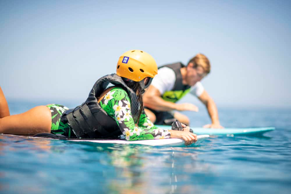 A person using a remote control to control a Fliteboard